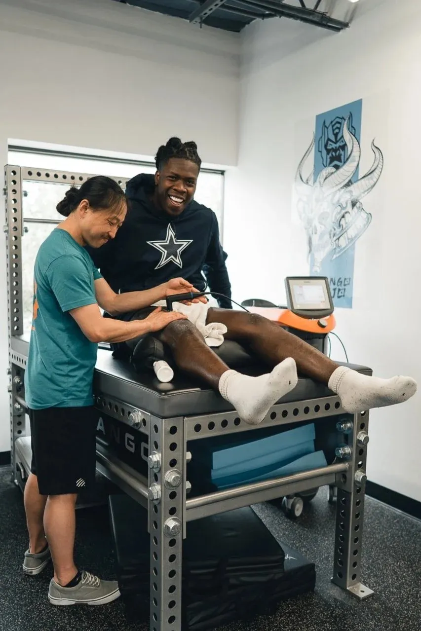 Dr. Kim treating a patient's leg on the table at the clinic